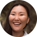 Young happy laughing asian woman walking in city